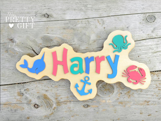 Personalised wooden name plaque for kids bedrooms or nursery rooms, featuring a lovely nauticle  theme. Customised with your child’s name, with the name  Available in different colour options and ideal as a baby shower, birthday, or nursery gift.