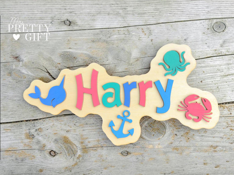 Personalised wooden name plaque for kids bedrooms or nursery rooms, featuring a lovely nauticle  theme. Customised with your child’s name, with the name  Available in different colour options and ideal as a baby shower, birthday, or nursery gift.
