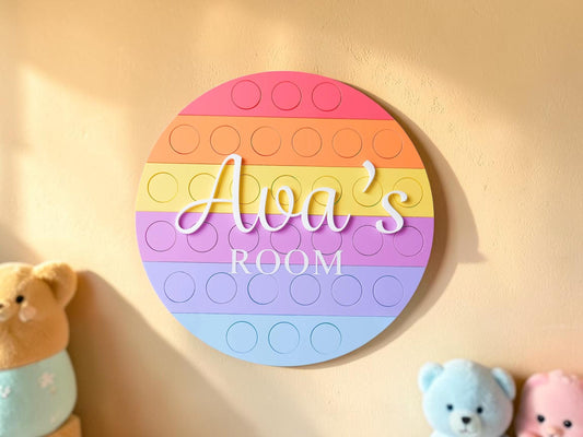 Personalised acrylic kids name plaque for bedrooms or nursery rooms, customised with your child’s name. Available in multiple colour options and ideal as wall decor for nurseries, playrooms, or kids bedrooms. Makes a thoughtful gift for birthdays, baby showers, or new baby presents. Pop-It inspired